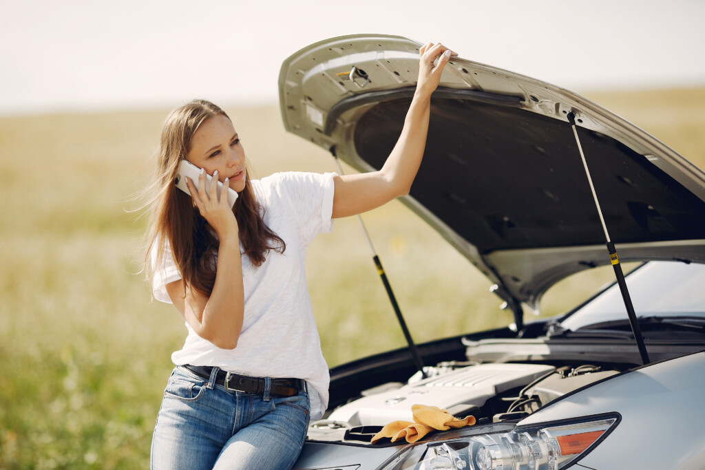 Nevada driver beside defective car during a Nevada lemon law lawyer consultation.