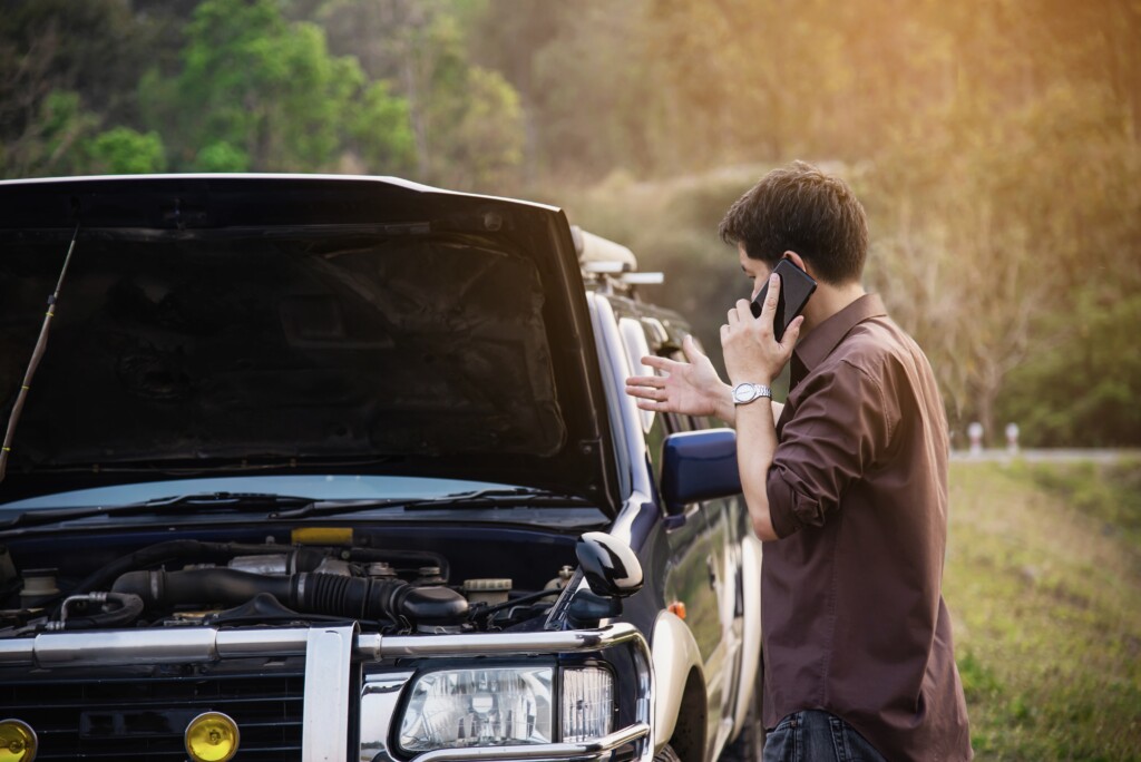 Repair documents on the hood of a defective car for a lemon law lawyer Los Angeles claim.